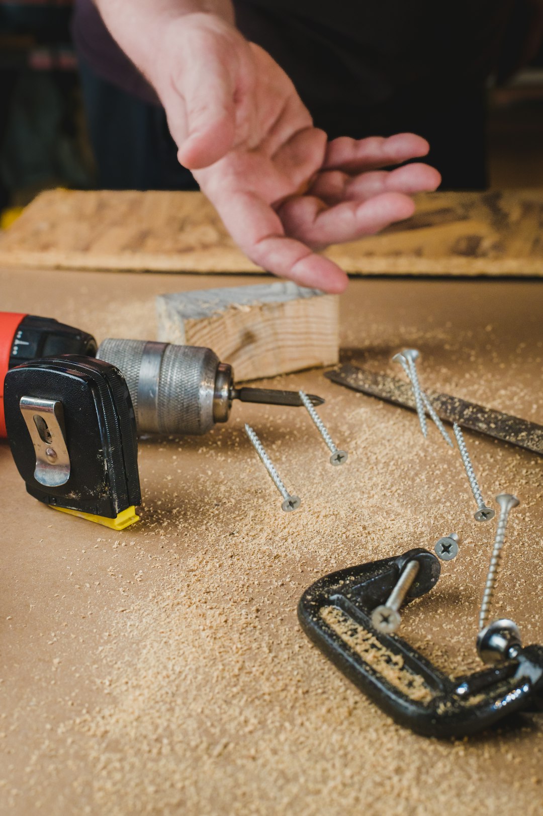 Carpenter throws screws on a workbench.